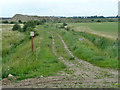 Track from sea wall towards old gravel pits in RM18 8RP