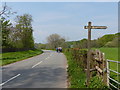 Footpath sign and walkers on the road in NP15 1NB