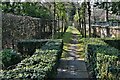 Over Peover: Well maintained path by the side of St. Lawrence's Church in WA16 9HJ