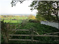 Boundary wall of Langton Hall and view across the valley of the Langton Beck in Langton