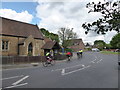 Cyclists passing St Peter, West Molesey in KT8 1QF