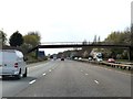 The M56 runs under a footbridge in WA7 6JH