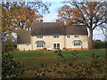 House seen from Aldham Priory track in IP7 6NT