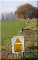 Warning sign at grassy landing strip - no fence in IP7 6LW