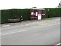 Bus stop, shelter and bench alongside a hedge, Pencader in SA39 9BP