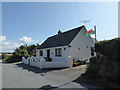 Cottage with the Welsh flag flying and selling plants in SA64 0LT