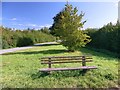 Bench on spare ground beside a minor road in NG23 6TE