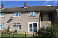 Pebbledashed house beside Westbury Walk in NN18 0TB