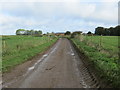 Fence-lined minor road approaching Littlecote Farm in MK18 3XZ