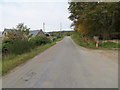 Tree and hedge-lined road at Lower Tillydrine in AB34 5AN