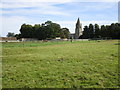 Grass field and the church of St. John the Baptist, Barnack in PE9 3DU