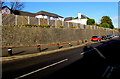 Wooden fencing on top of a long stone wall, Abbey Mead, Carmarthen in SA31 2EY