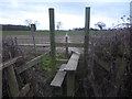 Stile leading across a muddy field in TN11 0LT