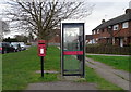 Elizabeth II postbox and telephone box on York Road, Barlby in YO8 5JP