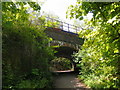 Path beneath Waterloo to Portsmouth line, with 450 class train running overhead in GU31 5SL