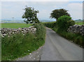 Minor road between Hutton Roof Crags and Newbiggin Crags in LA6 2PJ