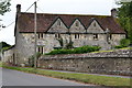 Stone houses overlooking the churchyard at Shroton in DT11 8PX