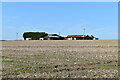 Farm buildings across stubble field above Idmiston in SP4 0PD