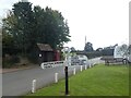Signpost, bus shelter and phone box, Halstock in BA22 9SF