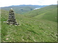 Cairn and hillside of Henderland Hill towards Megget Reservoir in TD7 5LG