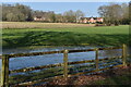 Waterlogged field with view of distant houses on Salisbury Road in SO51 6GN