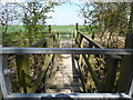 Metal footbridge at the field boundary in SY3 0BW