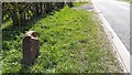 Damaged replacement milestone on east side of A7 south of Westlinton in CA6 6AG