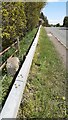 Milestone (Carlisle 9) behind safety barrier on north side of A6071 in CA6 5LH
