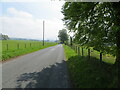 Fence-lined minor road in FK15 9LE