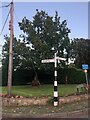 Signpost at junction of Oak Road and Priest Lane, Mottram St Andrew in SK10 4QW