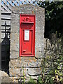 A Georgian letterbox with a benchmark in SN12 8HQ