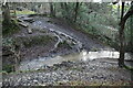 Muddy footpath fords stream in TN21 9NL