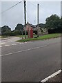 Red phonebox between poles, Cobblers Plain, Monmouthshire in NP16 6NR