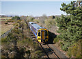 Train passing Muir of Ord in Muir of Ord