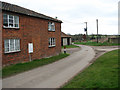 Road south past cottages opposite Church Farm in NR17 1DE