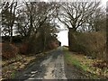 Minor road passing a dismantled railway bridge near Skares in KA18 2RD