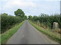 Hedge enclosed minor road at Pickworth Triangulation Pillar in Pickworth