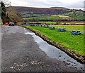 Picnic tables on grass, Llanhamlach, Powys in LD3 7YB