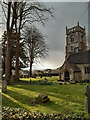 Evening sun and rain clouds over St. Leonard's churchyard in SN26 7DG