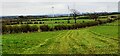 View over fields on SE side of Moor Road towards wind farm in Arthuret