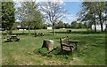 Seats by the pond at Eversley Cross in Eversley Cross
