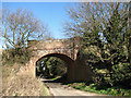 Railway bridge across unnamed country lane in NR28 0NF