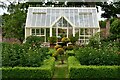 Elsing Hall and Gardens: Greenhouse with peonies within a box surround in NR20 3DX