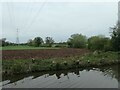 Newly-ploughed strip in a canalside field in WS13 8JE