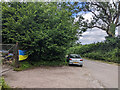 Car parked at the start of Fental Lane, Ukrainian flag on fence in BA4 4LF