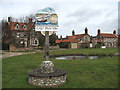 Village sign and pond at Low Common in NR27 9NX