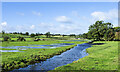 Stream and floodwater in field in CA11 0UQ