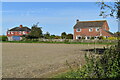 Houses on Burbage Road, seen from footpath across fields in SN9 5LT