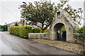 Road passing war memorial lych gate in IV36 2WT