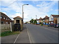 Bus stop and shelter on Rushden Road in NN10 9EZ
